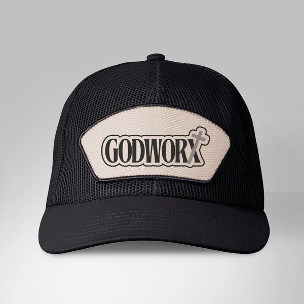 Black trucker cap with 'GODWORX' logo on a gray background