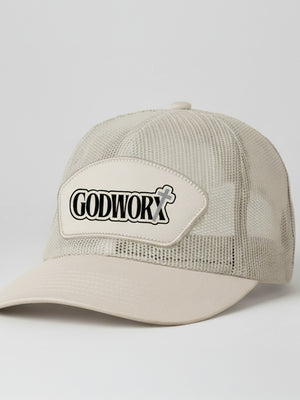 Khaki trucker cap with 'GODWORX' logo on a light gray background